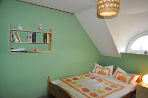 a bedroom with a bed and a book shelf at Ferienwohnung Landliebe 65347 in Moormerland