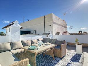 a patio with a couch and a table on a roof at Butterfly Bungalow - 9009 in Los Alcázares