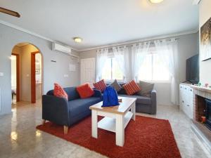 a living room with a couch and a table at Butterfly Bungalow - 9009 in Los Alcázares