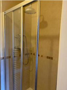 um chuveiro com uma porta de vidro na casa de banho em The Wayfarer, Robin Hoods Bay em Whitby