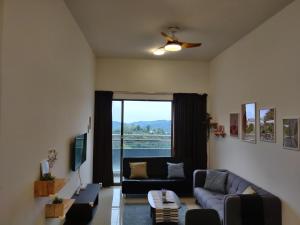 a living room with a couch and a window at Mars Homestay in Kea Farm Brinchang in Brinchang