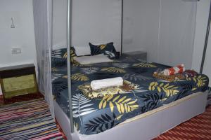 a bedroom with a bunk bed with blue and yellow sheets at Hare's BAR AND RESTAURANT in Canacona