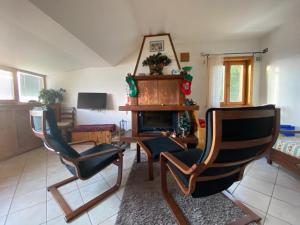 a living room with two chairs and a fireplace at b&b Rivisondoli in Rivisondoli