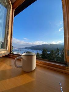 a coffee cup sitting in front of a window at b&b Rivisondoli in Rivisondoli