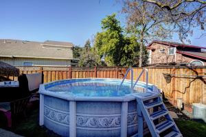 a hot tub in a yard with a ladder at with Pool & Hot Tub, Beautifully Appointed 4BR Home! home in Windsor