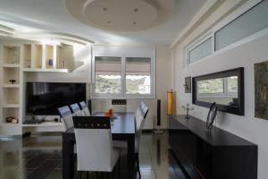 a dining room with a black table and chairs at Villa Sea View in Volos