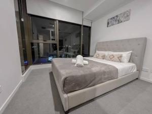 a bedroom with a large bed with a large window at 1.5BR apartment Fortitude Valley in Brisbane