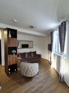 a living room with a couch and a chair at E&M Platinum in Kopaonik