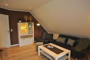 a living room with a couch and a table at Ferienwohnung Martens 65344 in Moormerland