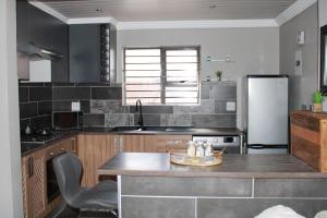 cocina con encimera y nevera en The Villa 442 en Pretoria