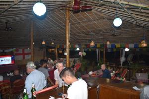 a group of people sitting at tables in a restaurant at Hare's BAR AND RESTAURANT in Canacona