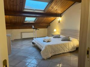 a bedroom with a large bed with a skylight at IL PALAZZO - Luxury Home & Event in Cosenza