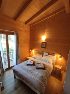 una camera con un grande letto in una baita di tronchi di Agriturismo La Soglia Del Parco a Ranica