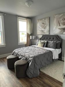 a bedroom with a large bed and two chairs at Macemia Place LLC in Baltimore