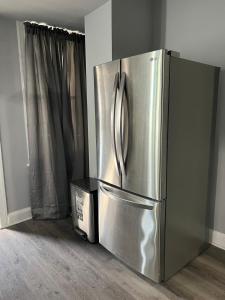 um frigorífico de aço inoxidável num quarto com uma caixa em Macemia Place LLC em Baltimore