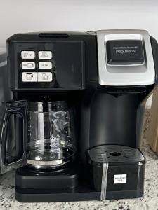 a coffeemaker with a coffee pot on top of it at Macemia Place LLC in Baltimore