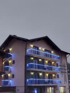 a building with blue lights on the side of it at FULG DE NEA in Sinaia