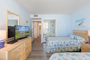 a bedroom with two beds and a flat screen tv at Fabulous Kingston Plantation 1009, Walk to Dining, Shops, Relax in Myrtle Beach