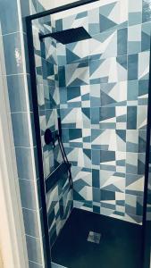 een badkamer met een douche met blauwe en witte tegels bij ANDREA'S HOUSE in Napels