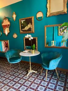 a blue room with two chairs and a table at Hotel Valentino in Catania