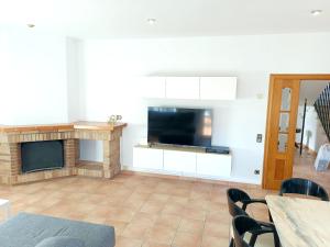 A television and/or entertainment centre at Bright Villa in Vidreres with Private Pool and Jacuzzi