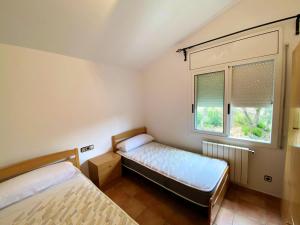 A bed or beds in a room at Bright Villa in Vidreres with Private Pool and Jacuzzi