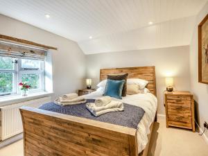 um quarto com uma cama grande e toalhas em Bridge Cottage em High Ham