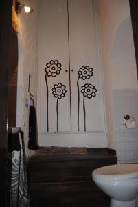 a bathroom with a window with flowers painted on it at Casa Gisira in Catania