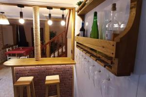 a bar with wine glasses on a wall at La Casa del Rio. in La Serna