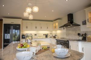 a kitchen with a counter with bowls of fruit on it at Tockwith Lodge Barn in York