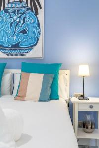 a bedroom with a bed with a blue and white at ApartUP Patacona Azzure in Valencia