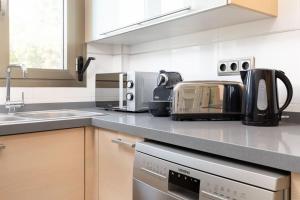 a kitchen with a counter top with some appliances at ApartUP Patacona Azzure in Valencia