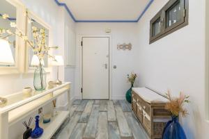 a room with a white door and a table with vases at ApartUP Patacona Azzure in Valencia