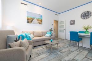 a living room with a couch and a table at ApartUP Patacona Azzure in Valencia