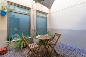 a small table and two chairs on a patio at ApartUP Patacona Azzure in Valencia