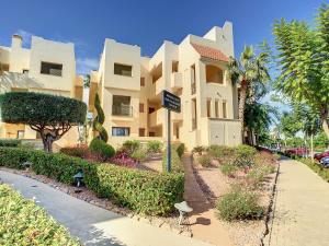 a building with a street sign in front of it at Roda Golf Resort - 8809 in San Javier