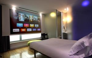 a bedroom with a bed and a flat screen tv at iRooms Forum & Colosseum in Rome