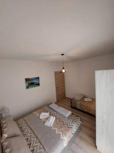 a room with two beds and a couch in it at Sky Apartment 1 in St. Paul's Bay