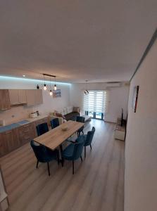 a kitchen and dining room with a wooden table and chairs at Sky Apartment 1 in St Paul's Bay