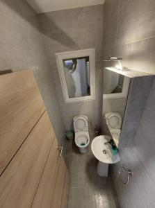 a small bathroom with two toilets and a sink at Sky Apartment 1 in St Paul's Bay