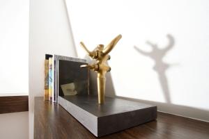 a bronze statue of an angel sitting on a shelf at Hotel Beau Séjour Lucerne in Luzern