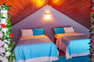 a room with two beds in a attic at Lakeville Residence in Nuwara Eliya
