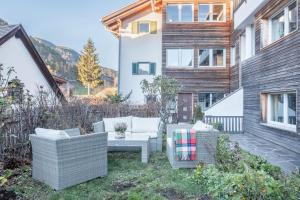 a backyard with wicker chairs and a table at Vorderschöneck 1 in Longomoso