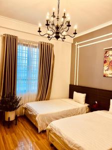 Giường trong phòng chung tại Mộc Hương Hotel