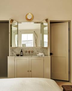 a bathroom with a sink and a large mirror at Inness in Accord