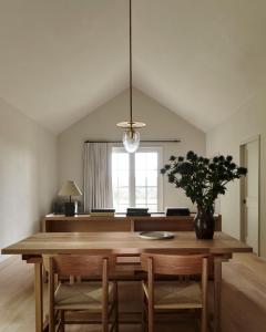 a dining room with a wooden table and chairs at Inness in Accord