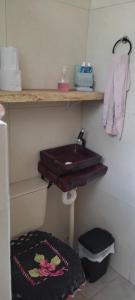a bathroom with a wooden sink and a towel at Cabana rustica logcabin com banheira aquecida in Osório