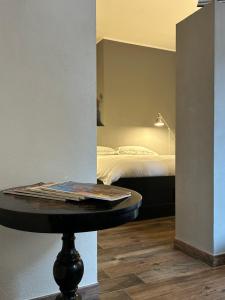 a room with a bed and a table with a bed at charming new loft in Bologna