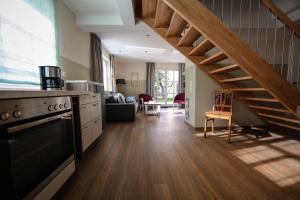 a kitchen with a staircase and a living room at Ferienhaus Christina in Bad Windsheim