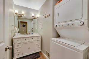 a white bathroom with a sink and a mirror at Harbor Cove Shores in Harbor Springs